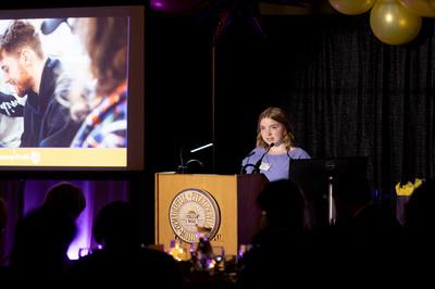 Student speaking at a podium